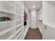 Well-organized walk-in closet with white shelving and drawers, providing ample storage space at 8719 E San Marino Dr, Scottsdale, AZ 85258