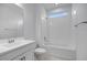 Bright bathroom featuring a tub-shower combo and a modern single sink vanity at 8865 W Orange Dr, Glendale, AZ 85305