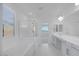 Luxurious primary bathroom with double sinks, a soaking tub, and glass shower at 8865 W Orange Dr, Glendale, AZ 85305