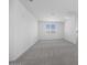 Spacious bedroom with neutral carpet, white walls, and a window providing natural light at 8865 W Orange Dr, Glendale, AZ 85305