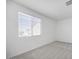 Well-lit bedroom featuring a large window and neutral carpet at 8865 W Orange Dr, Glendale, AZ 85305