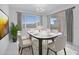 Bright dining room with modern chandelier, white table setting, and sliding door access to the outdoor patio at 8865 W Orange Dr, Glendale, AZ 85305