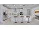 Modern kitchen features stainless steel appliances, a kitchen island with seating, and ample cabinet space at 8865 W Orange Dr, Glendale, AZ 85305