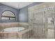 Modern bathroom with a separate tub and shower, featuring elegant tile work at 8911 E Sutton Dr, Scottsdale, AZ 85260