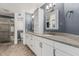 Bathroom with double sink vanity, granite counters, and a shower with glass door at 8911 E Sutton Dr, Scottsdale, AZ 85260