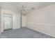 This is a carpeted bedroom with neutral walls, a ceiling fan and closet at 8911 E Sutton Dr, Scottsdale, AZ 85260