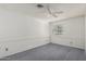 This is a carpeted bedroom with a ceiling fan and window at 8911 E Sutton Dr, Scottsdale, AZ 85260