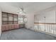 Open bonus room with built in shelves, desk space and carpet flooring at 8911 E Sutton Dr, Scottsdale, AZ 85260