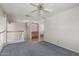 Upstairs carpeted bonus room with staircase and adjacent room view at 8911 E Sutton Dr, Scottsdale, AZ 85260