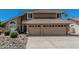 Charming two-story home featuring a clay tile roof, an attached two car garage, and desert landscaping at 8911 E Sutton Dr, Scottsdale, AZ 85260