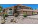 Charming two-story home featuring a clay tile roof, an attached two car garage, and desert landscaping at 8911 E Sutton Dr, Scottsdale, AZ 85260
