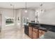 Bright kitchen with a breakfast bar that overlooks an open living area and backyard at 8911 E Sutton Dr, Scottsdale, AZ 85260