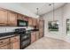 Well-lit kitchen showcasing stainless steel appliances and ample cabinet space at 8911 E Sutton Dr, Scottsdale, AZ 85260