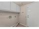 The laundry room has neutral walls, tile floors, and storage cabinets at 8911 E Sutton Dr, Scottsdale, AZ 85260
