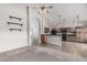 Bright and airy living room featuring carpet, floating shelves, and an arched doorway leading to the kitchen at 8911 E Sutton Dr, Scottsdale, AZ 85260