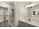 Bathroom features quartz countertops, framed mirror, and glass-enclosed shower at 9555 E Raintree Dr # 1055, Scottsdale, AZ 85260
