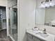 Beautiful bathroom boasts quartz countertops, framed mirror, and glass-enclosed shower at 9555 E Raintree Dr # 1055, Scottsdale, AZ 85260