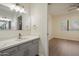 Bright bathroom featuring modern vanity with white countertop and gray cabinets plus view to bedroom at 9555 E Raintree Dr # 1055, Scottsdale, AZ 85260