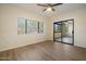 Bedroom with wood-look floors, window, and sliding glass doors to the patio at 9555 E Raintree Dr # 1055, Scottsdale, AZ 85260