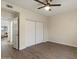 Spacious bedroom with ceiling fan, closet, and wood-look flooring at 9555 E Raintree Dr # 1055, Scottsdale, AZ 85260