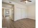 Comfortable bedroom features wood-look floors, closet with sliding doors and view to hallway at 9555 E Raintree Dr # 1055, Scottsdale, AZ 85260