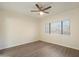 Spacious bedroom with wood-look floors, window, and ceiling fan at 9555 E Raintree Dr # 1055, Scottsdale, AZ 85260