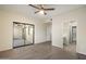 Bright bedroom boasts wood-look floors, ceiling fan, and mirrored closet doors at 9555 E Raintree Dr # 1055, Scottsdale, AZ 85260