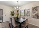Dining room featuring contemporary chandelier and view of the landscaped outdoors at 9555 E Raintree Dr # 1055, Scottsdale, AZ 85260