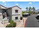 Inviting condo featuring an assigned parking spot with a stucco exterior and well-maintained landscaping at 9555 E Raintree Dr # 1055, Scottsdale, AZ 85260