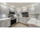Bright kitchen showcases gray cabinets, stainless steel appliances, marbled countertops, and gray subway tile backsplash at 9555 E Raintree Dr # 1055, Scottsdale, AZ 85260
