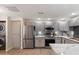 Bright kitchen showcasing stainless steel appliances, light countertops, and wood-look flooring at 9555 E Raintree Dr # 1055, Scottsdale, AZ 85260
