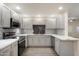 Fully renovated kitchen features recessed lighting, gray cabinets, stainless steel appliances, and marbled countertops at 9555 E Raintree Dr # 1055, Scottsdale, AZ 85260