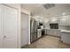 Full kitchen view with stainless steel refrigerator and appliances, modern countertops, and new laminate flooring at 9555 E Raintree Dr # 1055, Scottsdale, AZ 85260