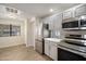 Kitchen area with stainless steel refrigerator, modern countertop, and gray appliances at 9555 E Raintree Dr # 1055, Scottsdale, AZ 85260