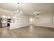 Spacious living room shows new floors and lighting, with an open floor plan into a modern kitchen at 9555 E Raintree Dr # 1055, Scottsdale, AZ 85260