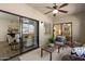 Relaxing patio with comfortable seating, ceiling fan, and sliding glass doors at 9555 E Raintree Dr # 1055, Scottsdale, AZ 85260