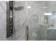 Modern shower with sleek fixtures and elegant marble-style tiling at 9555 E Raintree Dr # 1055, Scottsdale, AZ 85260