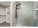 Modern shower with wall-mounted shower system, glass enclosure, and tiled walls at 9555 E Raintree Dr # 1055, Scottsdale, AZ 85260