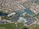 Expansive aerial view showcasing the community's layout with lush golf course, tennis courts, and scenic lakes at 9649 E Holiday Way, Sun Lakes, AZ 85248