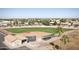 Aerial view of a well-maintained baseball field with dugouts, bleachers, and surrounding neighborhood at 9649 E Holiday Way, Sun Lakes, AZ 85248