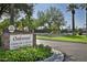 Elegant community entrance sign nestled among colorful flowerbeds and mature trees at 9649 E Holiday Way, Sun Lakes, AZ 85248