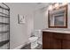 Charming powder room features granite counters, wood-look floors, and a sleek vanity with ample storage at 9736 E Ironwood Dr, Scottsdale, AZ 85258