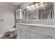 Bright bathroom with dual sinks, granite counters, decorative mirrors, and modern fixtures, creating a spa-like ambiance at 9736 E Ironwood Dr, Scottsdale, AZ 85258