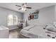 Comfortable bedroom offers natural light, wood-look floors, white trim and ample space for a desk or seating area at 9736 E Ironwood Dr, Scottsdale, AZ 85258