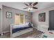 Comfortable bedroom with wood-look floors, neutral paint, and a large window, perfect for a cozy retreat at 9736 E Ironwood Dr, Scottsdale, AZ 85258