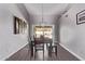 Bright dining room with stylish decor, wood-look floors, and sliding doors overlooking the backyard and pool at 9736 E Ironwood Dr, Scottsdale, AZ 85258