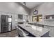 Modern kitchen with a large island, stainless steel appliances, and white cabinets at 9736 E Ironwood Dr, Scottsdale, AZ 85258