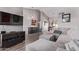Spacious living room features wood-look floors and neutral paint, with a large sectional couch and a modern entertainment center at 9736 E Ironwood Dr, Scottsdale, AZ 85258