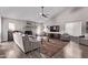 Cozy living room with a fireplace, comfortable seating, and a ceiling fan at 9736 E Ironwood Dr, Scottsdale, AZ 85258
