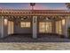 Relaxing covered patio with tiled flooring, ceiling fans, and ambient string lights perfect for outdoor entertaining at 9736 E Ironwood Dr, Scottsdale, AZ 85258